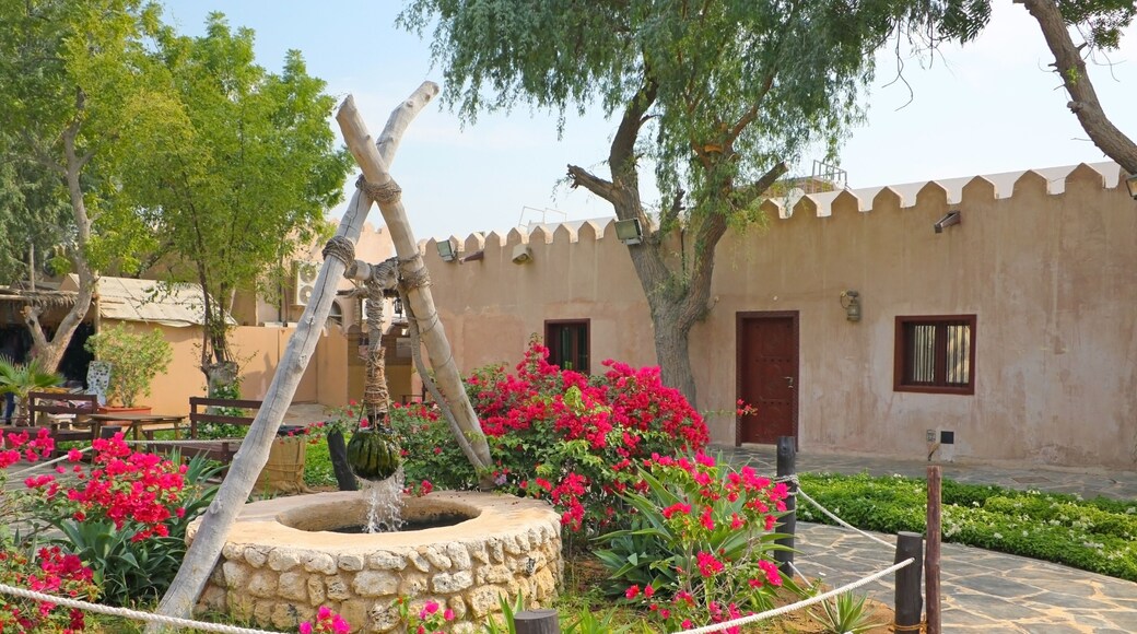 Traditional stone house and well in the front garden at the Heritage village, Abu Dhabi, United Arab Emirates.