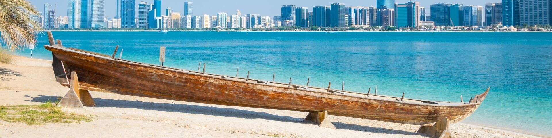 Wooden boat at the Heritage Village, in front of the Abu Dhabi skyline, United Arab Emirates; Shutterstock ID 608354351; Purchase Order: -