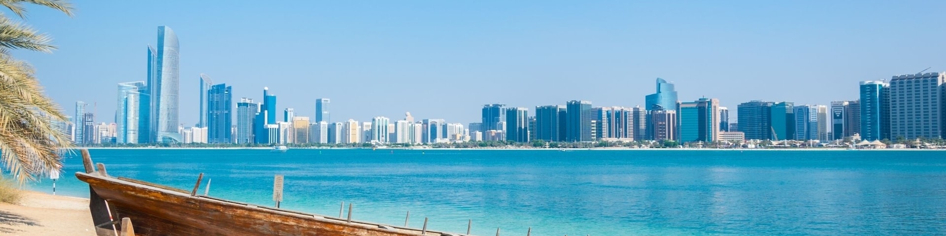 Wooden boat at the Heritage Village, in front of the Abu Dhabi skyline, United Arab Emirates; Shutterstock ID 608354351; Purchase Order: -