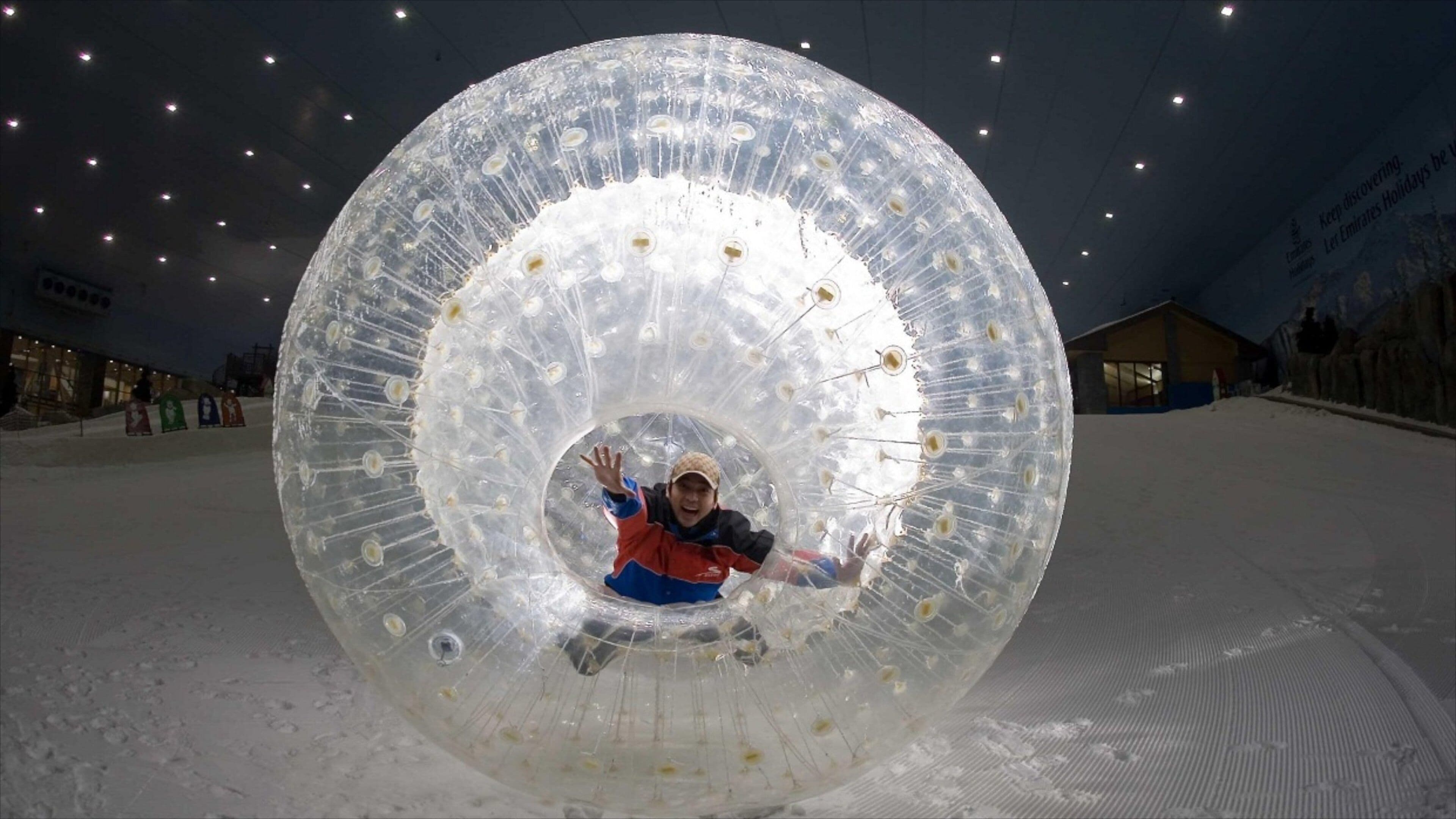 Ski Dubai featuring snow and night scenes as well as an individual male