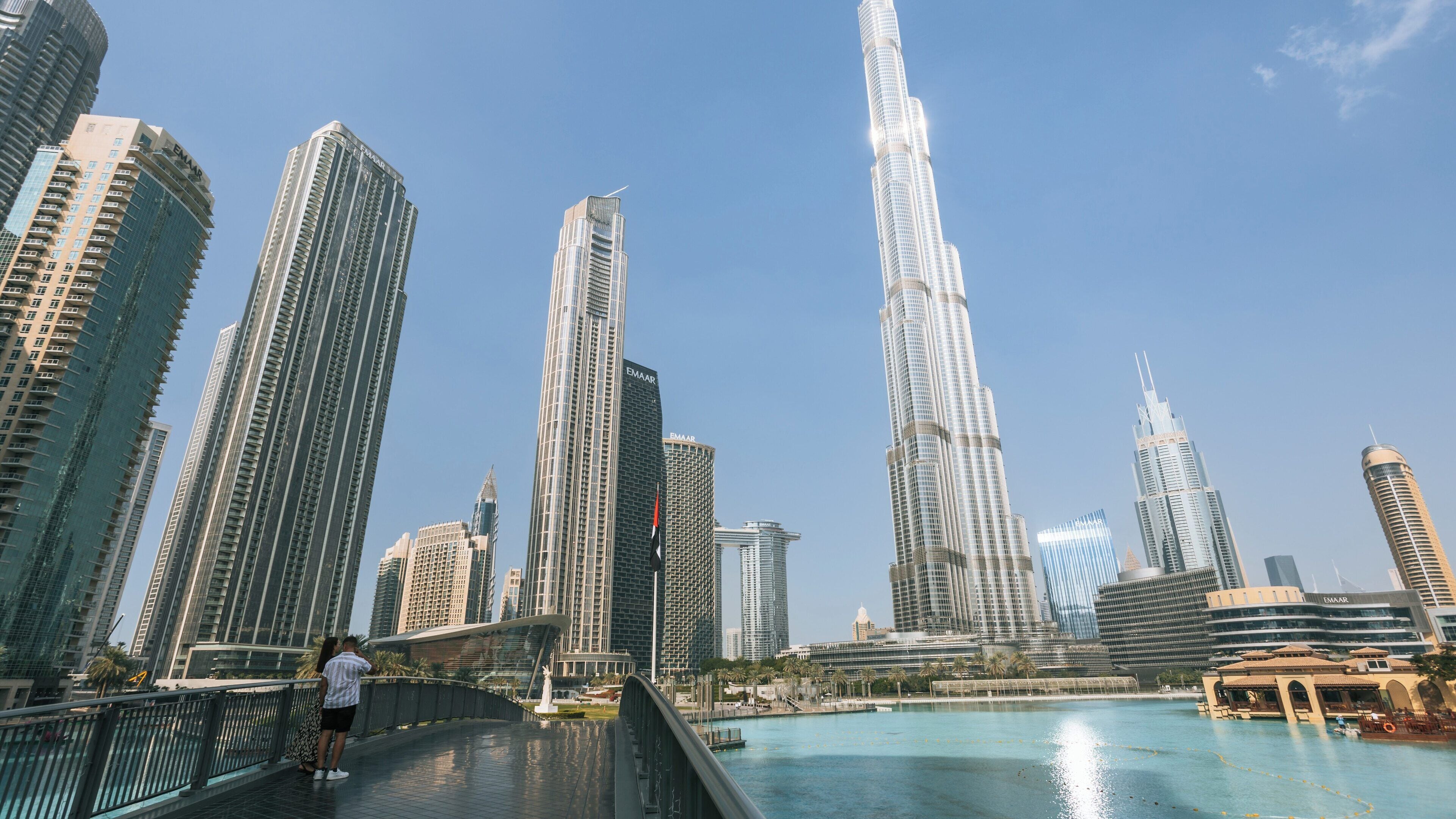 View of Burj Khalifa towering over Downtown Dubai with modern skyscrapers and azure water creating a stunning urban landscape