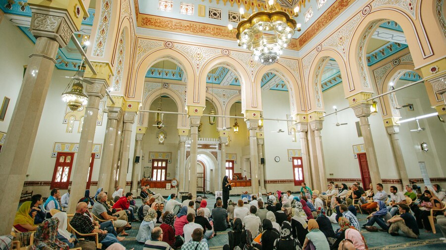 Jumeirah Mosque which includes a mosque and interior views as well as a large group of people
