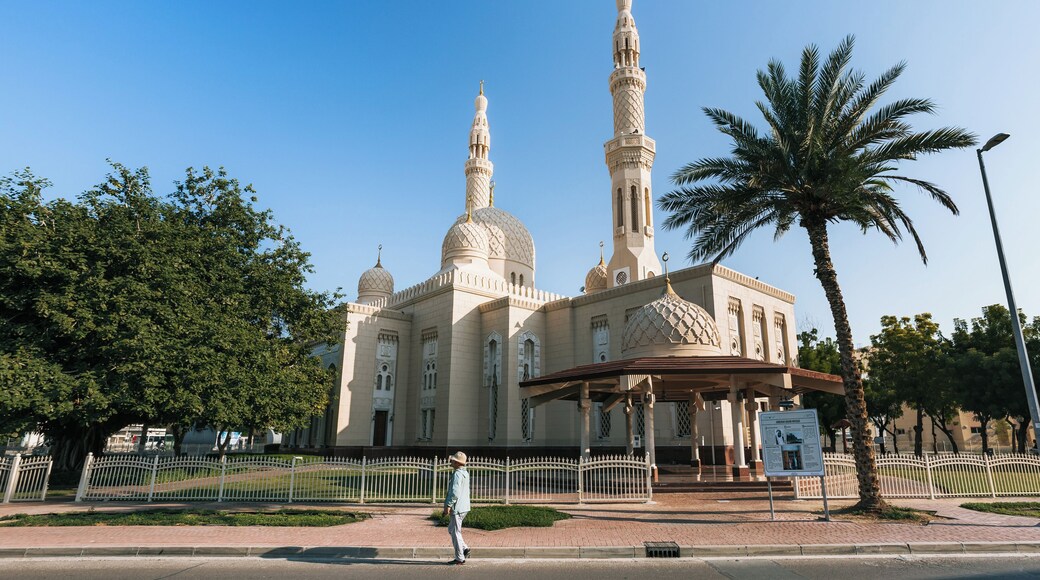 A large mosque with two minarets, a dome, and a surrounding fence.
