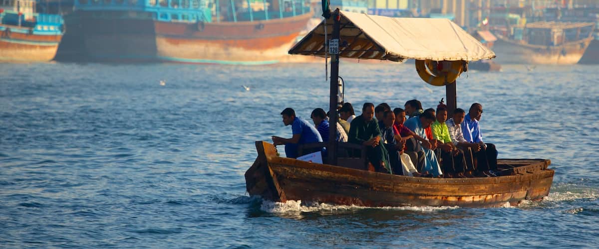 Dubai Creek which includes a coastal town, boating and a bay or harbor