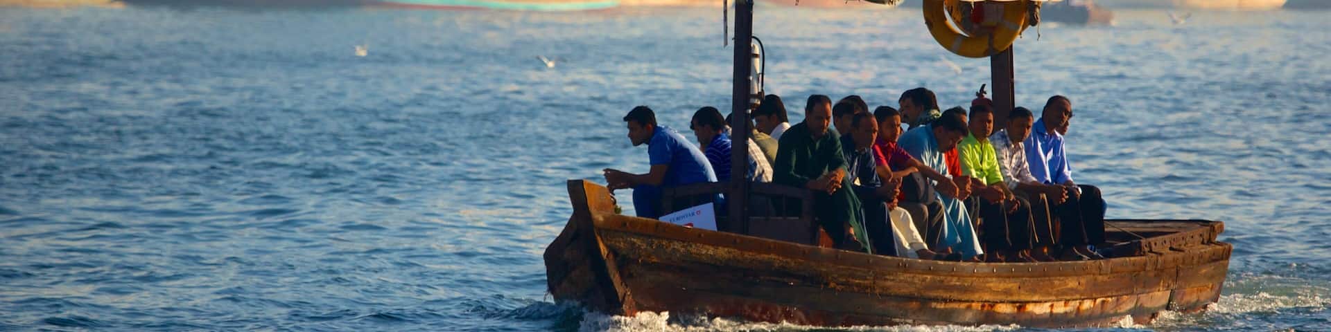 Dubai Creek which includes a coastal town, boating and a bay or harbor