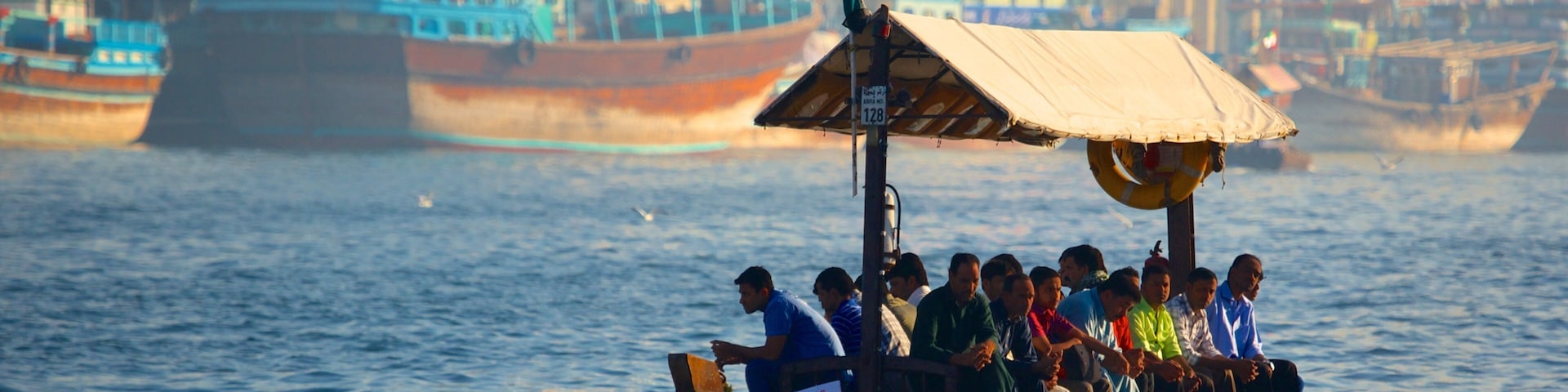 Dubai Creek showing a bay or harbour, boating and a coastal town