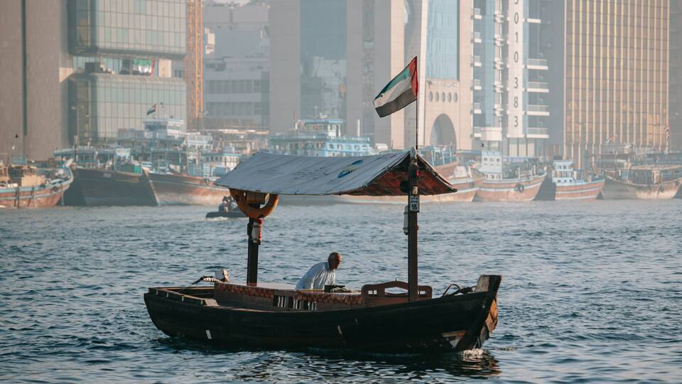 Dubai Creek which includes boating and a bay or harbor as well as an individual male