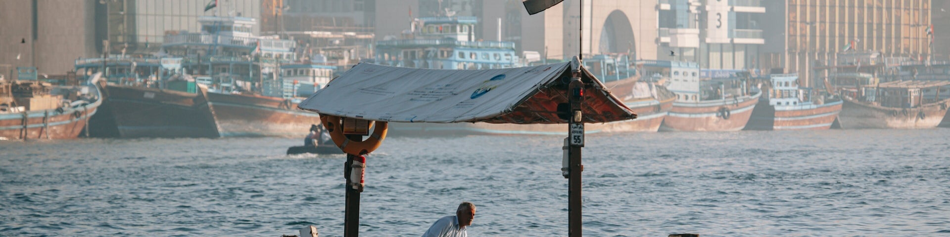 Dubai Creek which includes boating and a bay or harbor as well as an individual male