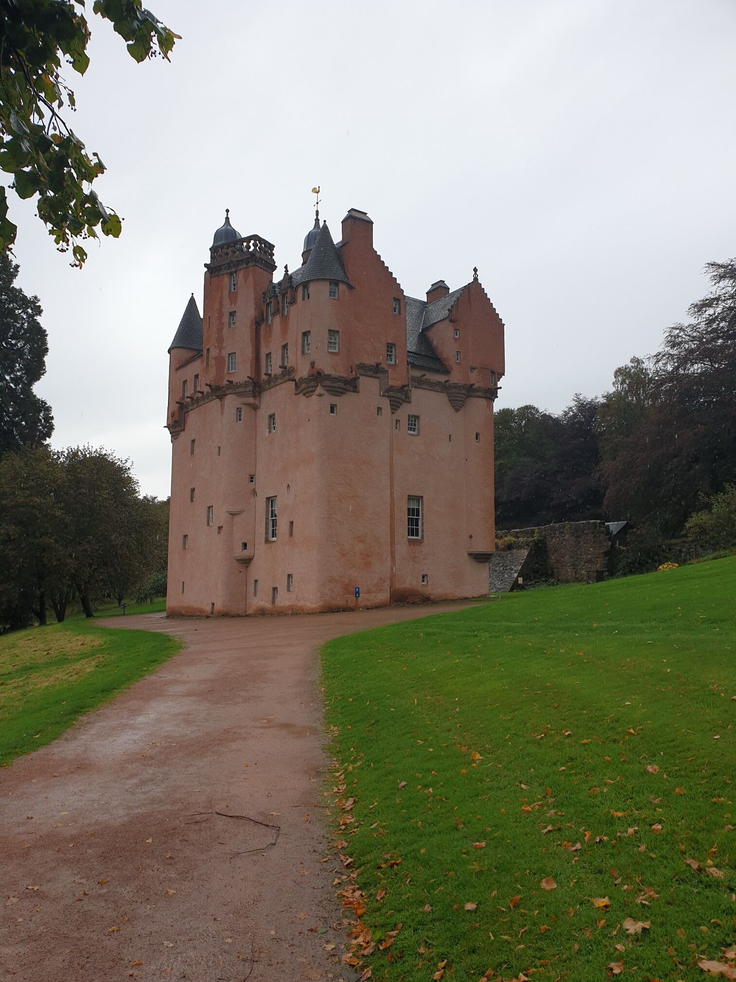The castle with the first of the golden autumn leaves on the ground