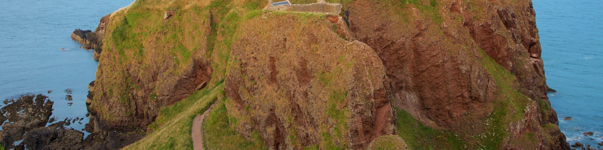 Dunnottar Castle showing general coastal views, farmland and heritage elements