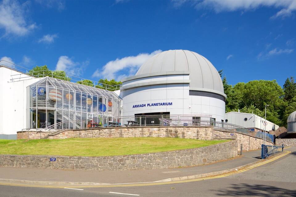 The Armagh Planetarium with a large dome and a glass enclosure displaying the solar system.