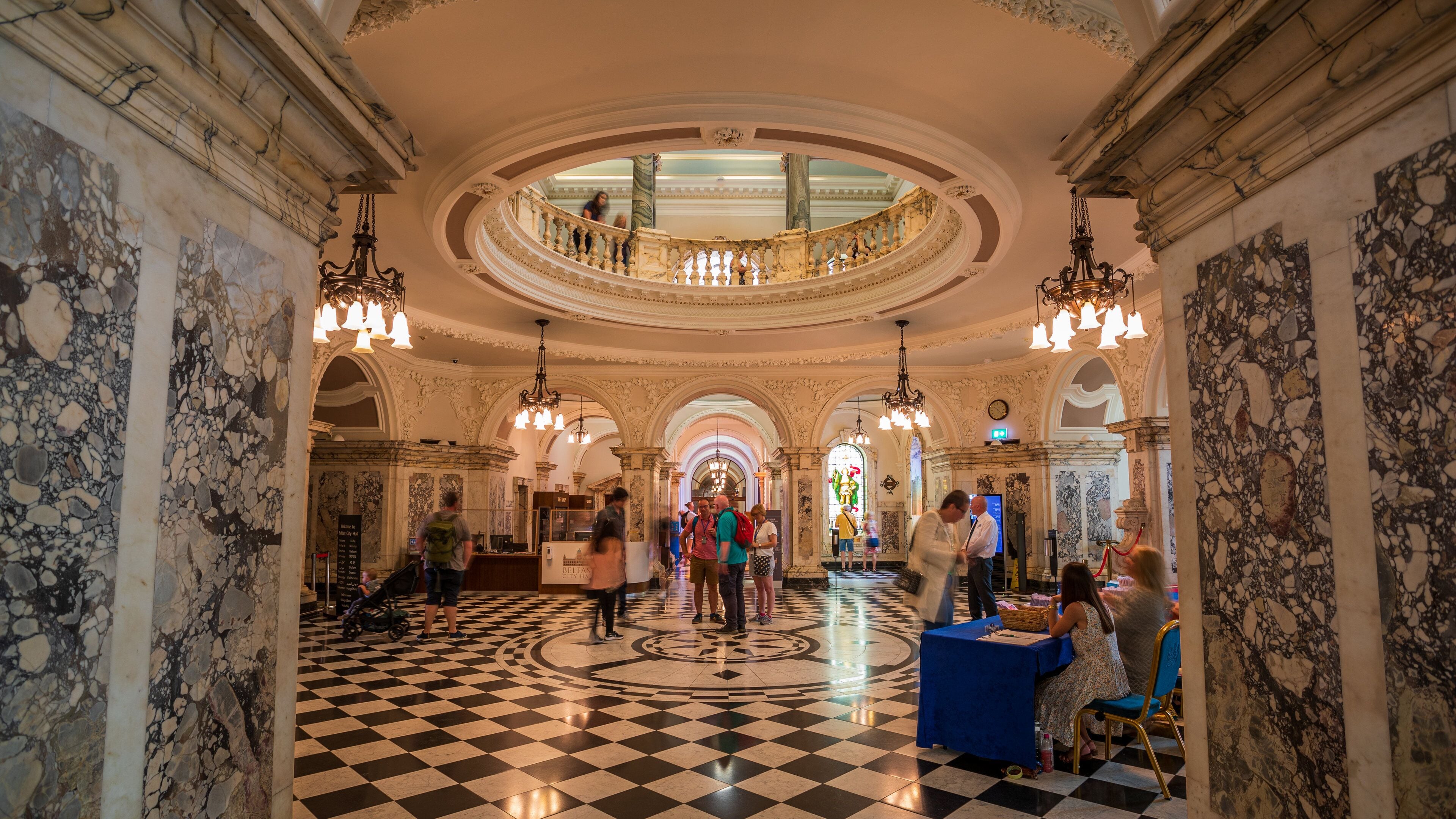 Belfast City Hall showing interior views and heritage elements as well as a small group of people