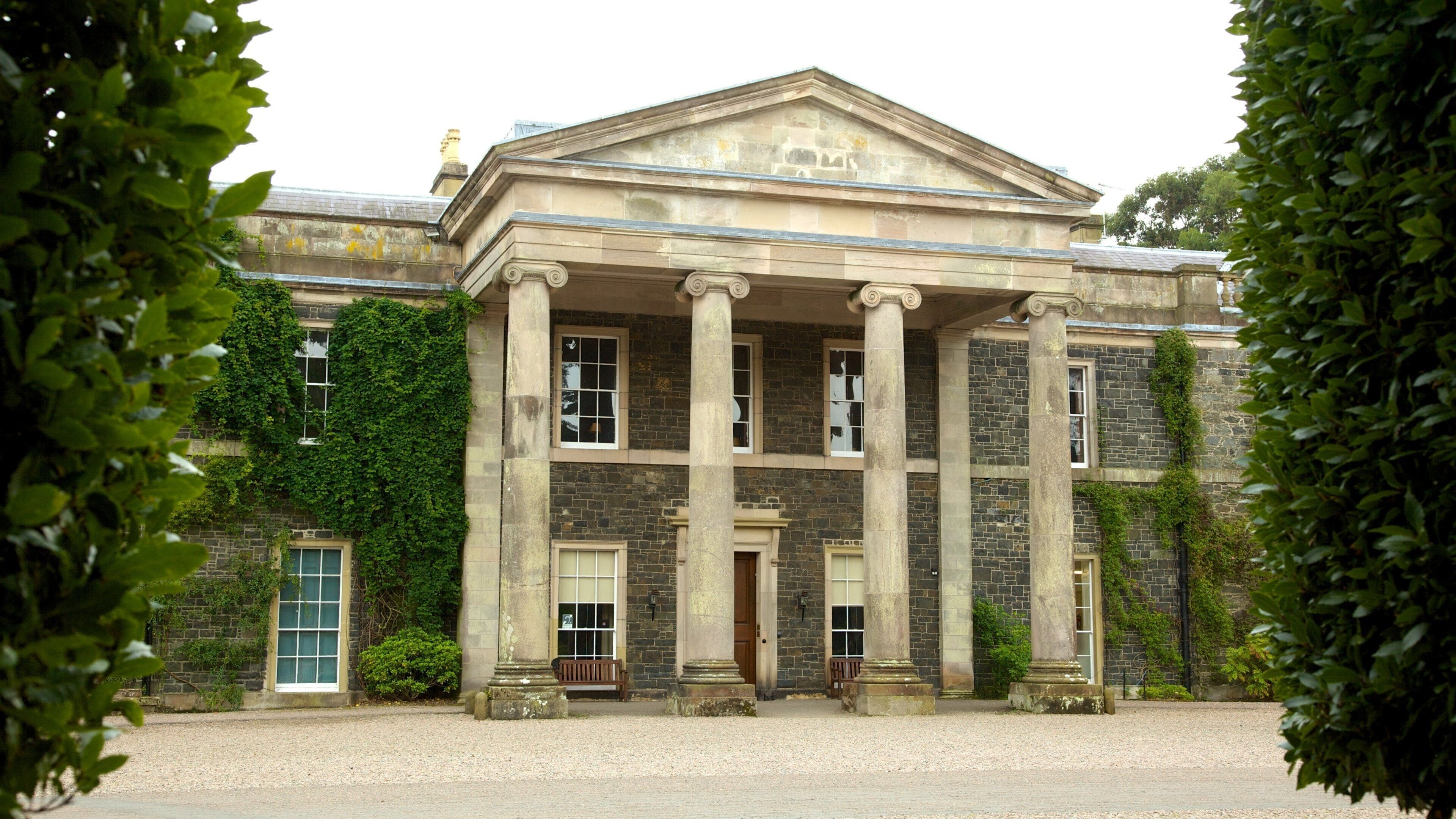 A historic building with a classical facade, large columns, and a symmetrical design.