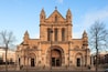 A large, historic church with a prominent central archway and two towers.