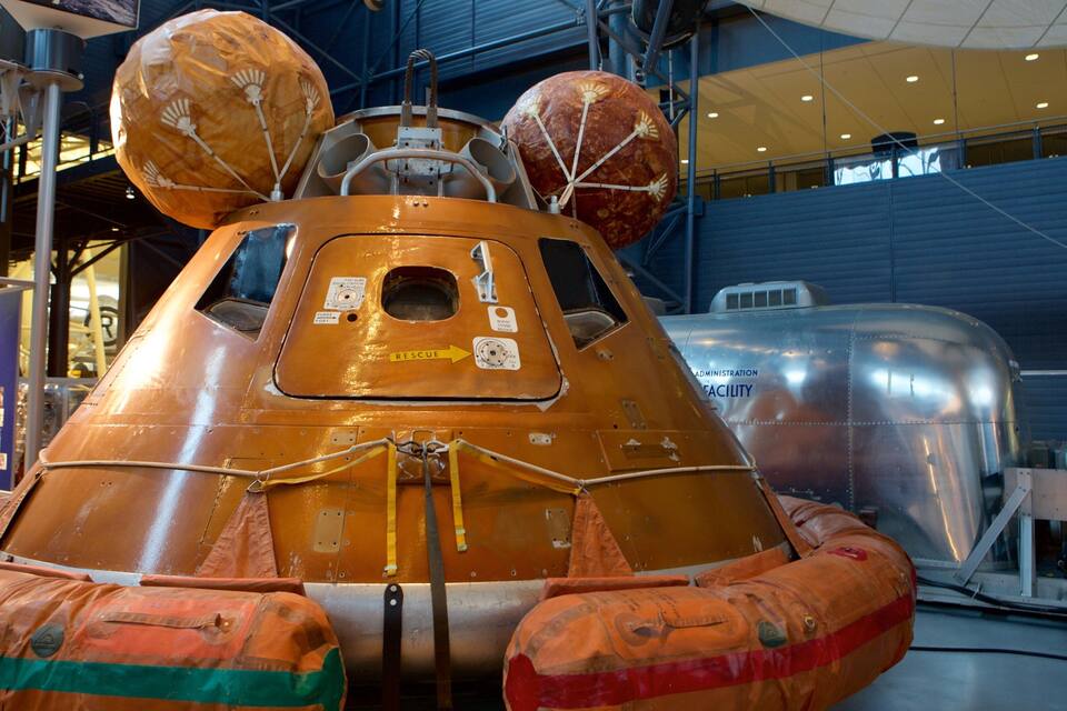A space shuttle on display with a large, spherical nose cone and two spherical modules on top.