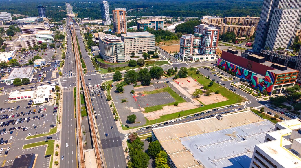 Aerial view of Tysons Virginia with metro line and modern buildings under summer sky