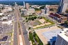 Aerial view of Tysons Virginia with metro line and modern buildings under summer sky