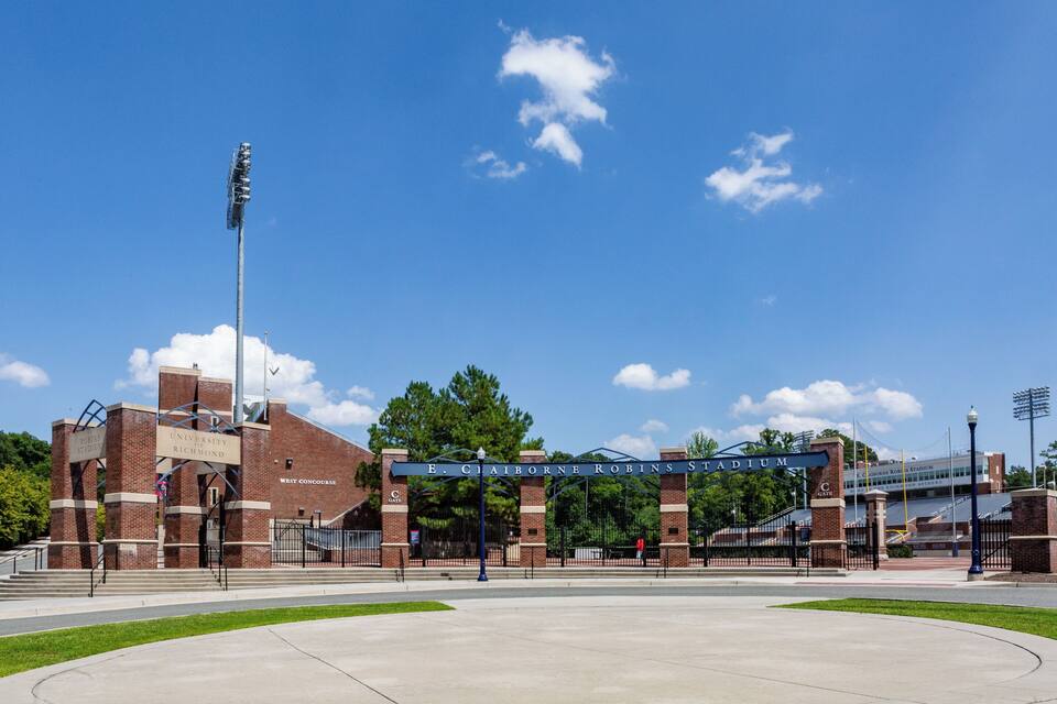 E. Claiborne Robins Stadium with a clear blue sky and a few clouds.