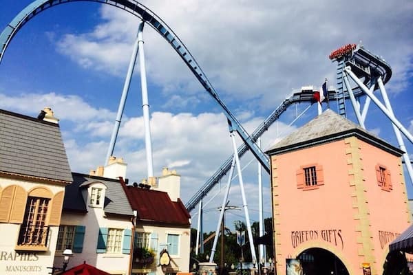A roller coaster, a building labeled 'Griffon Gifts', and a building with 'Manuscripts' signage.