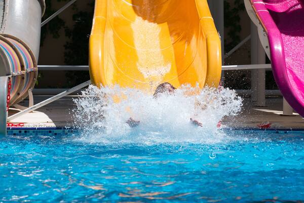 girl rolls down the water slides at the water park