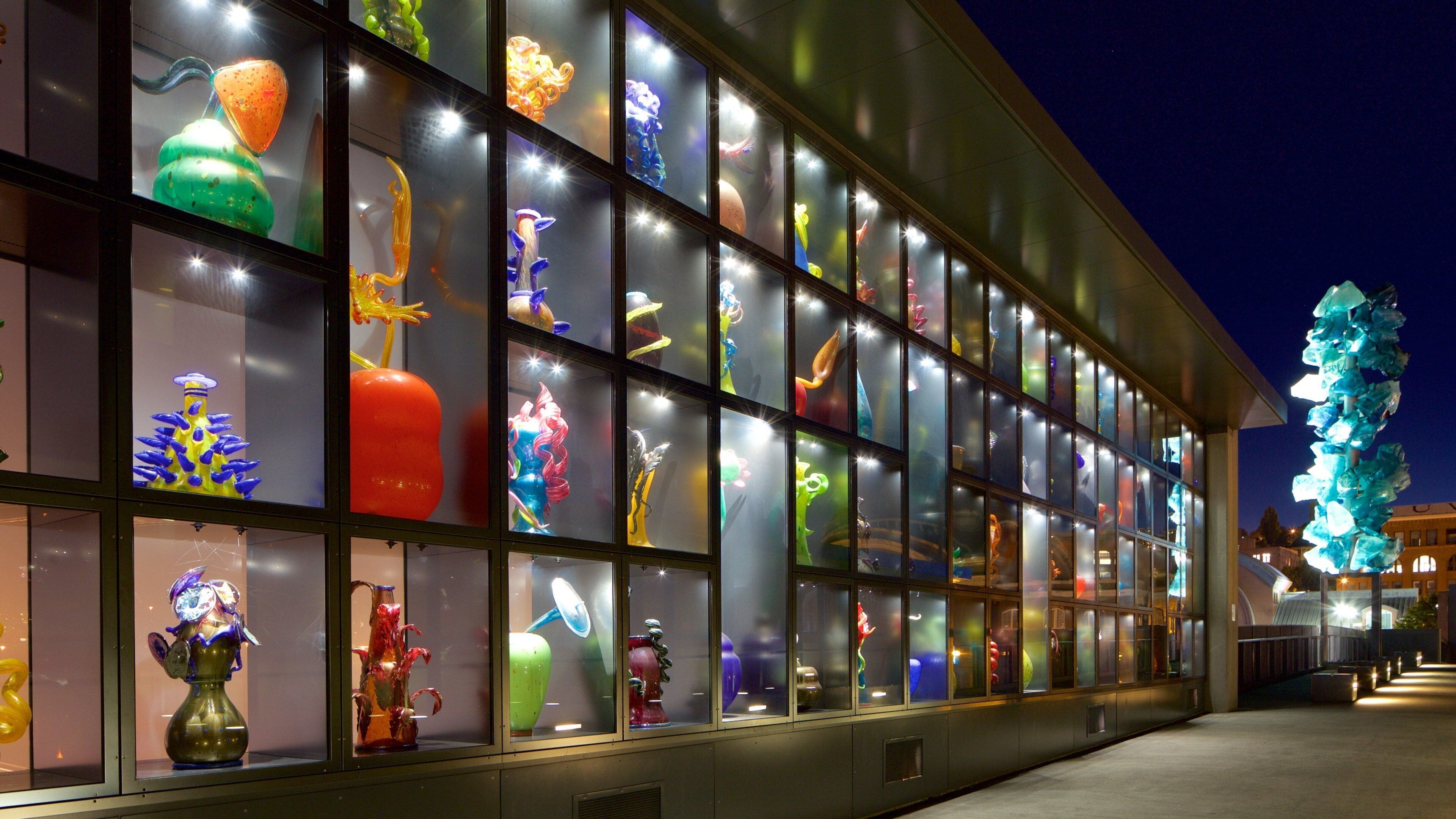 A building with colorful glass sculptures displayed in the windows.
