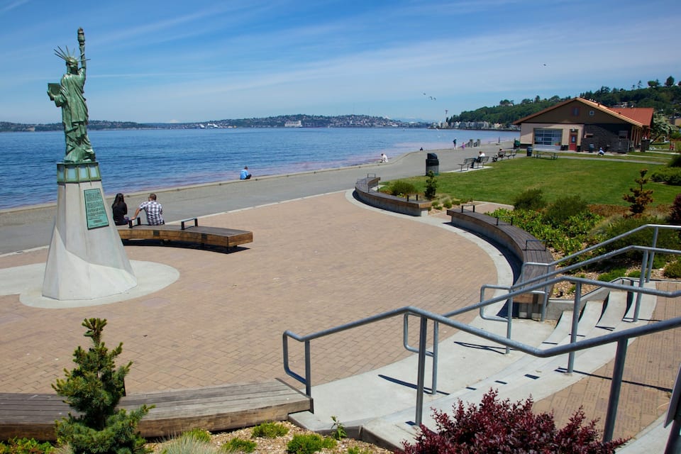 A beach with a statue, a building, and a staircase.
