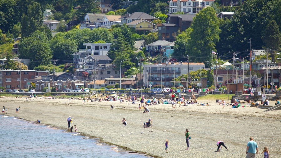 Vibrant summer day at Alki Beach in Seattle with families enjoying sun and sand by the waterfront