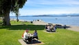 Casual gatherings at Alki Beach with views of the water and mountains in Seattle, Washington on a sunny day