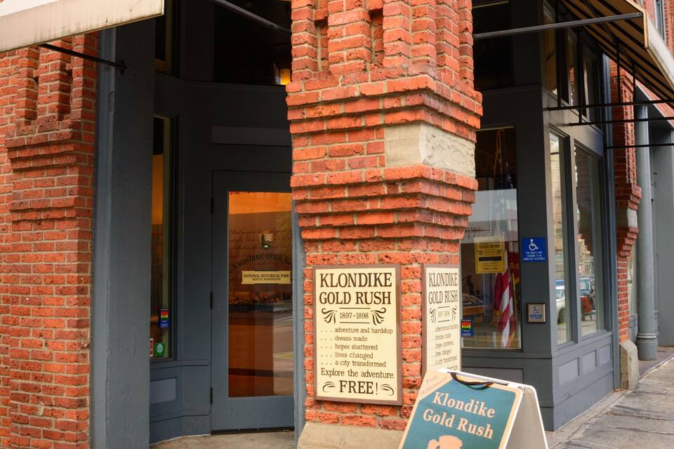 A brick building with a sign for Klondike Gold Rush National Historical Park.