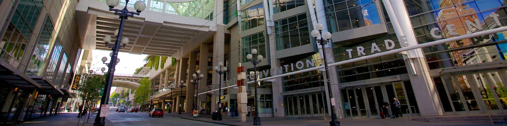 A modern shopping mall with a glass ceiling and large windows.