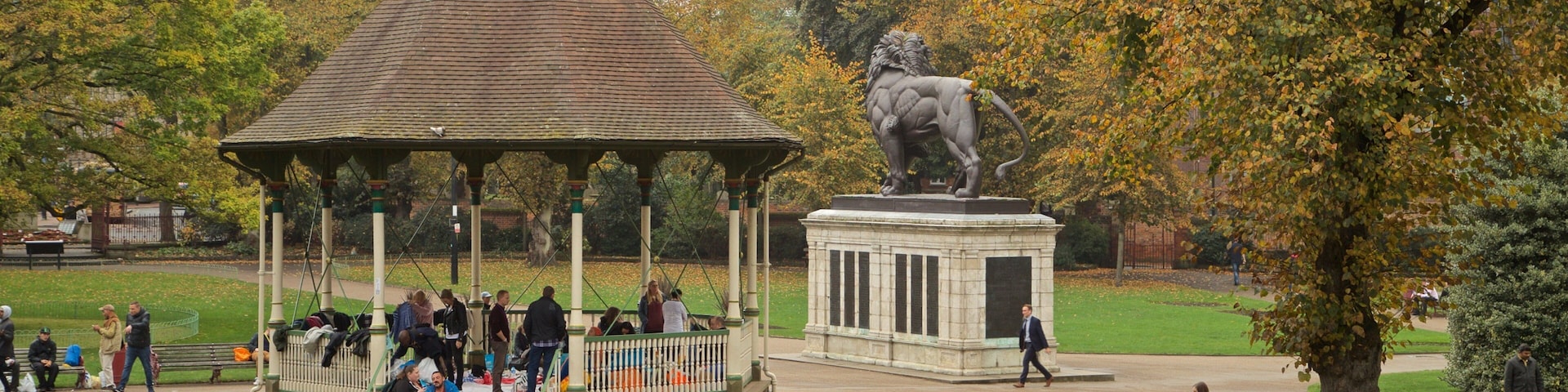 Forbury Gardens featuring a garden as well as a small group of people