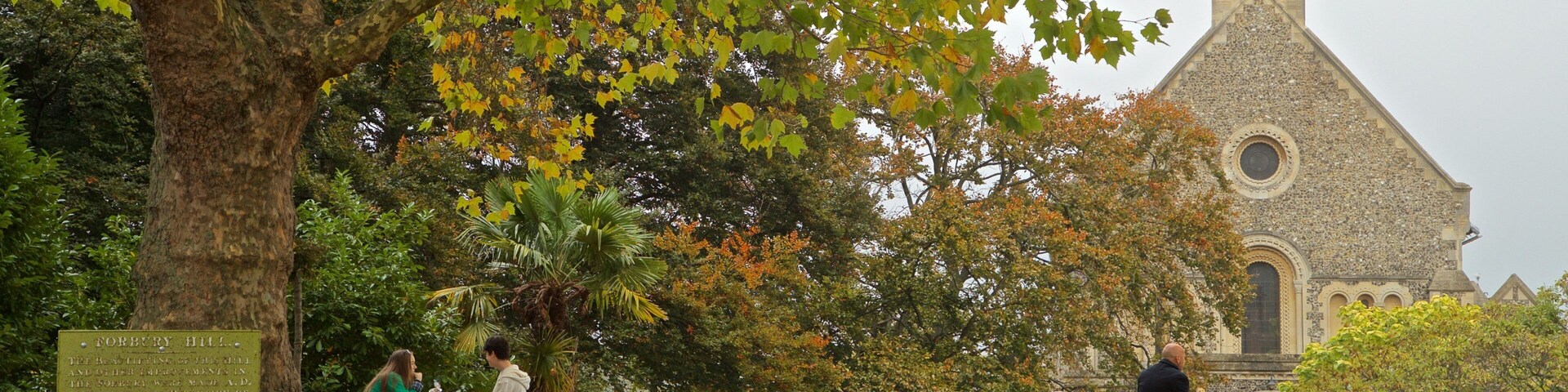 Forbury Gardens showing a church or cathedral, a garden and fall colors