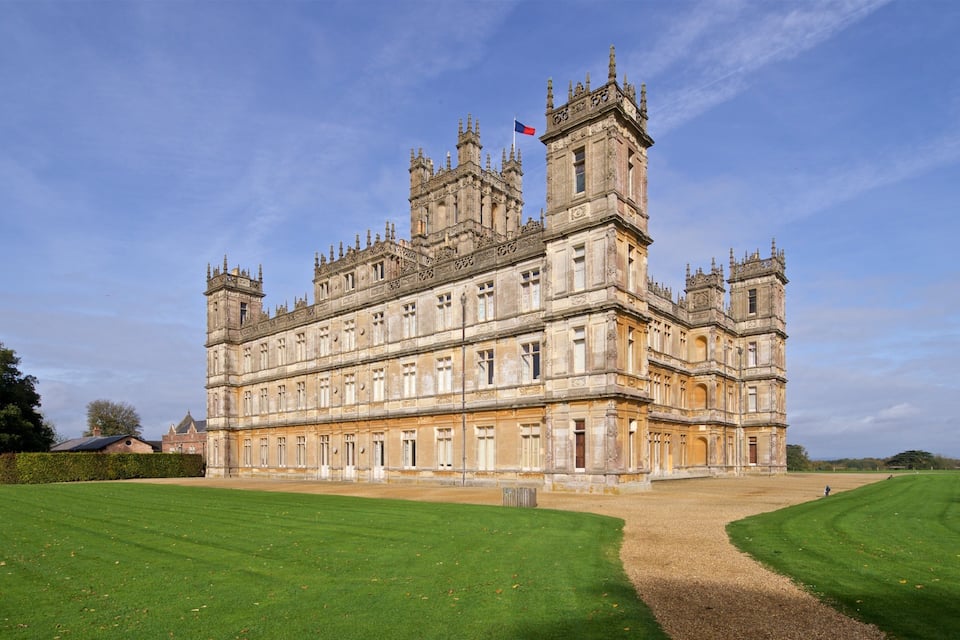 A large, ornate castle with multiple towers and a flag.