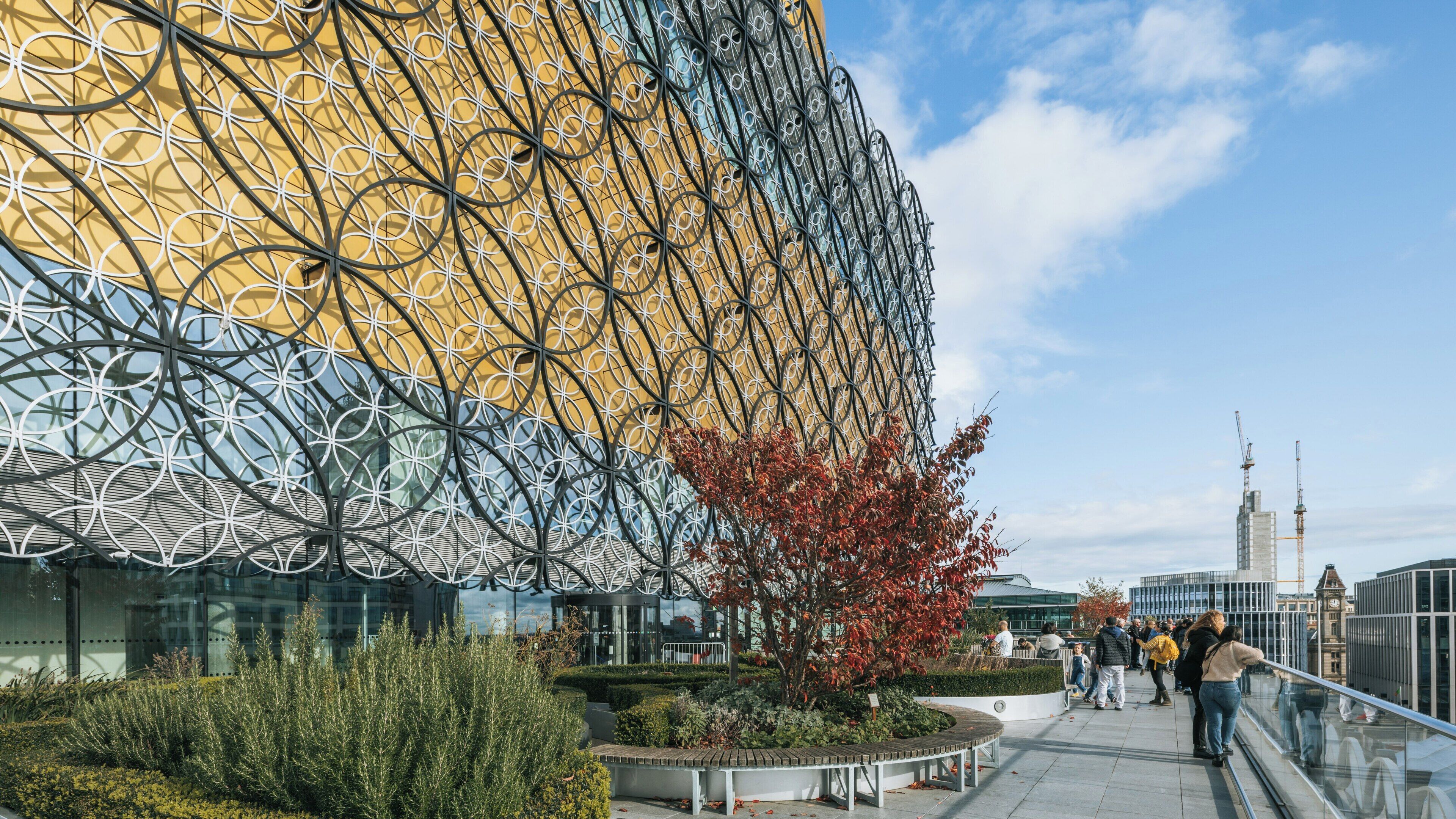 Birmingham City Centre features the modern architecture of the Library of Birmingham surrounded by vibrant city life