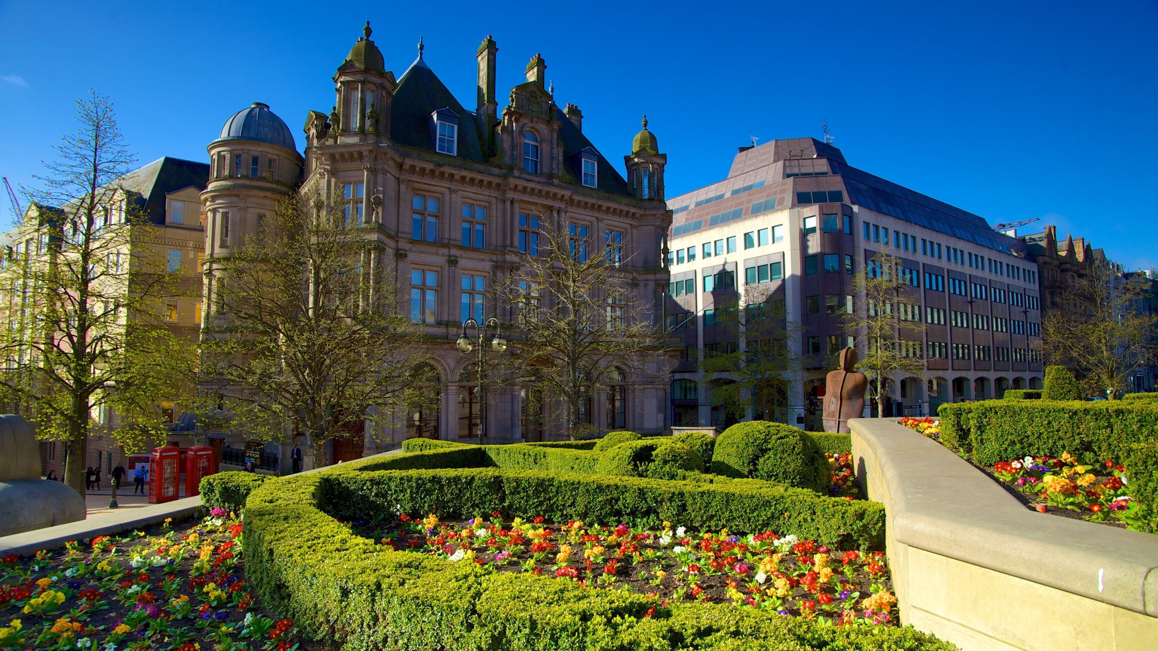 A historic building with ornate architecture and a modern adjacent structure.