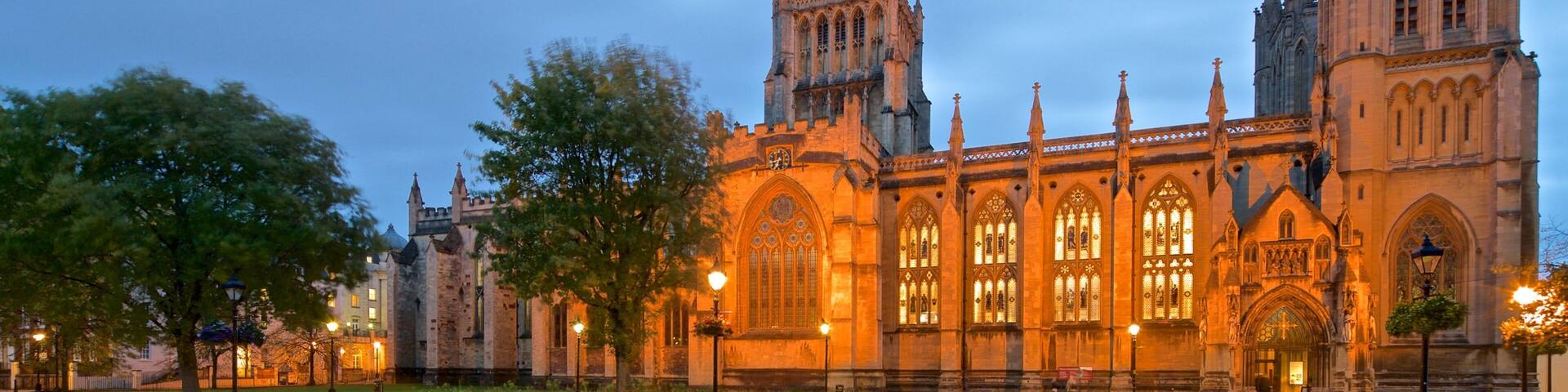 A historic building with Gothic architecture, featuring pointed arches and a clock tower.