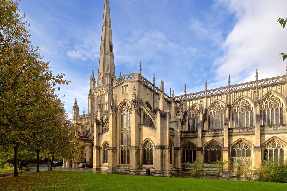A historic cathedral with intricate Gothic architecture, including pointed arches and a tall spire.