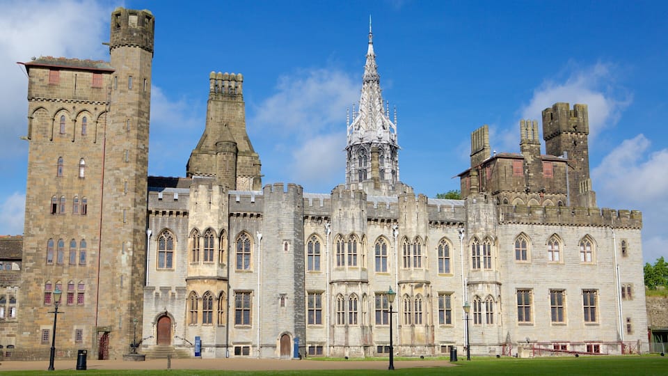 A historic castle with multiple towers, a spire, and arched windows.