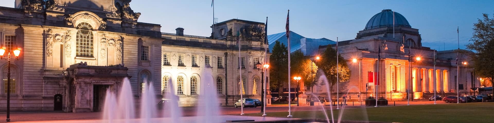 Cardiff City Hall (1906) and fountains at night in the heart of the capital, city Museum to the right.