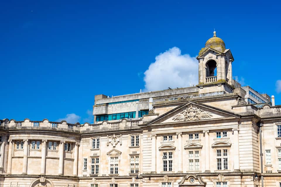 A historic building with classical architecture, including a prominent dome and detailed facade.