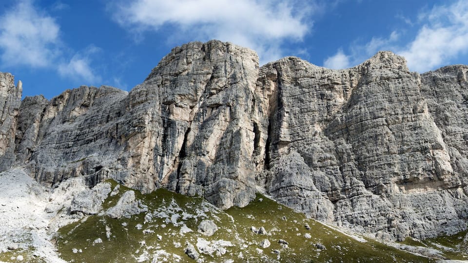 A rugged mountain range with sharp peaks and rocky terrain.