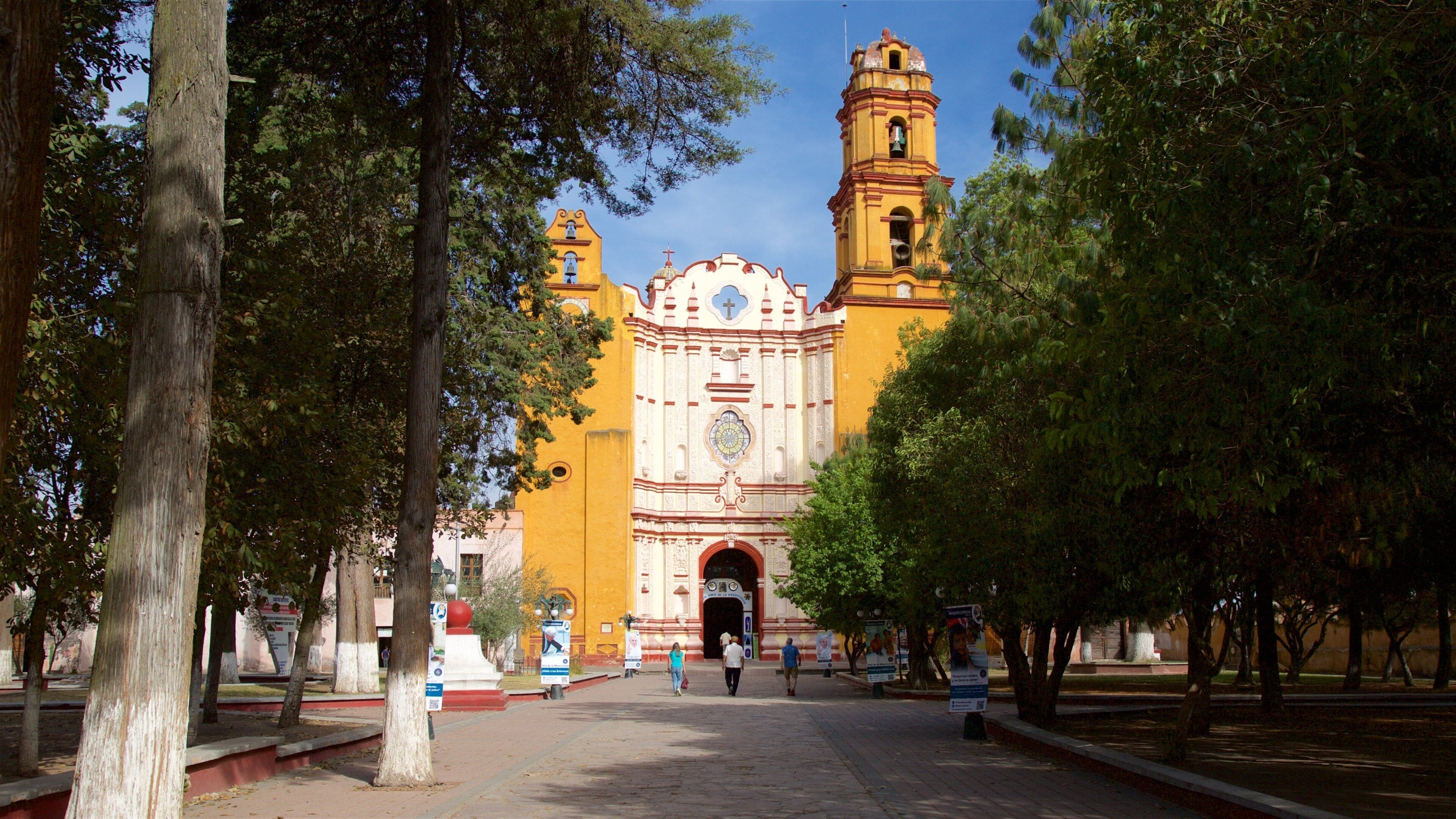 A historic church with a bell tower and a large arched entrance.