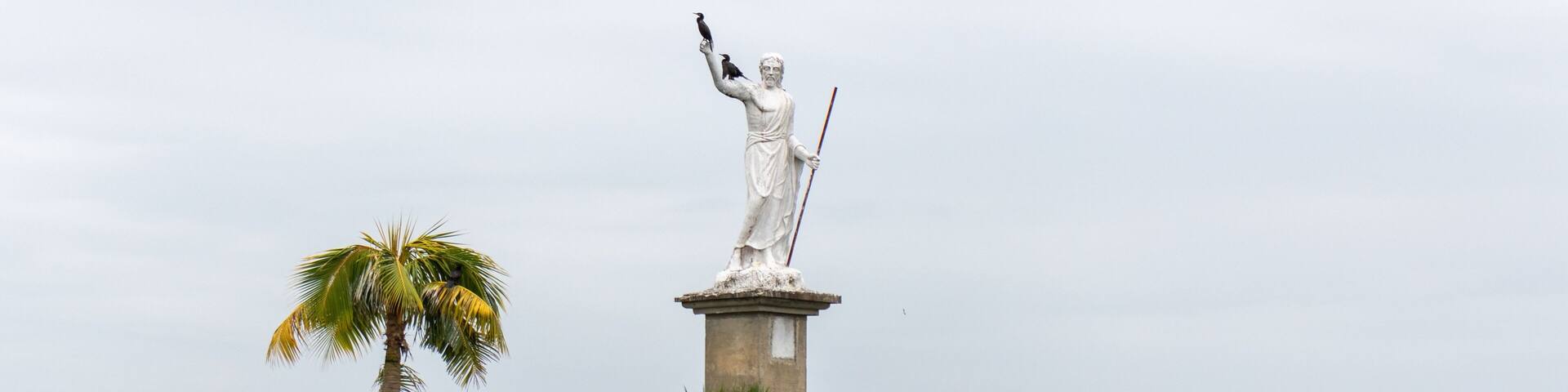 Statue of the god of the sea with pelicans on it in Livingston, Guatemala