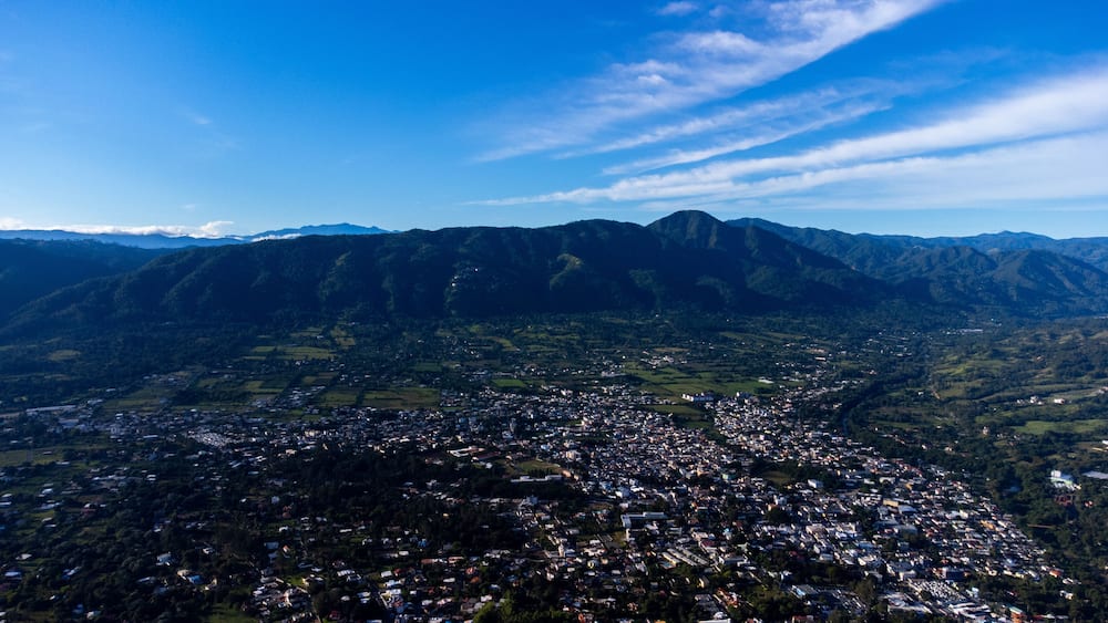 A mountainous landscape with a town nestled in the valley.
