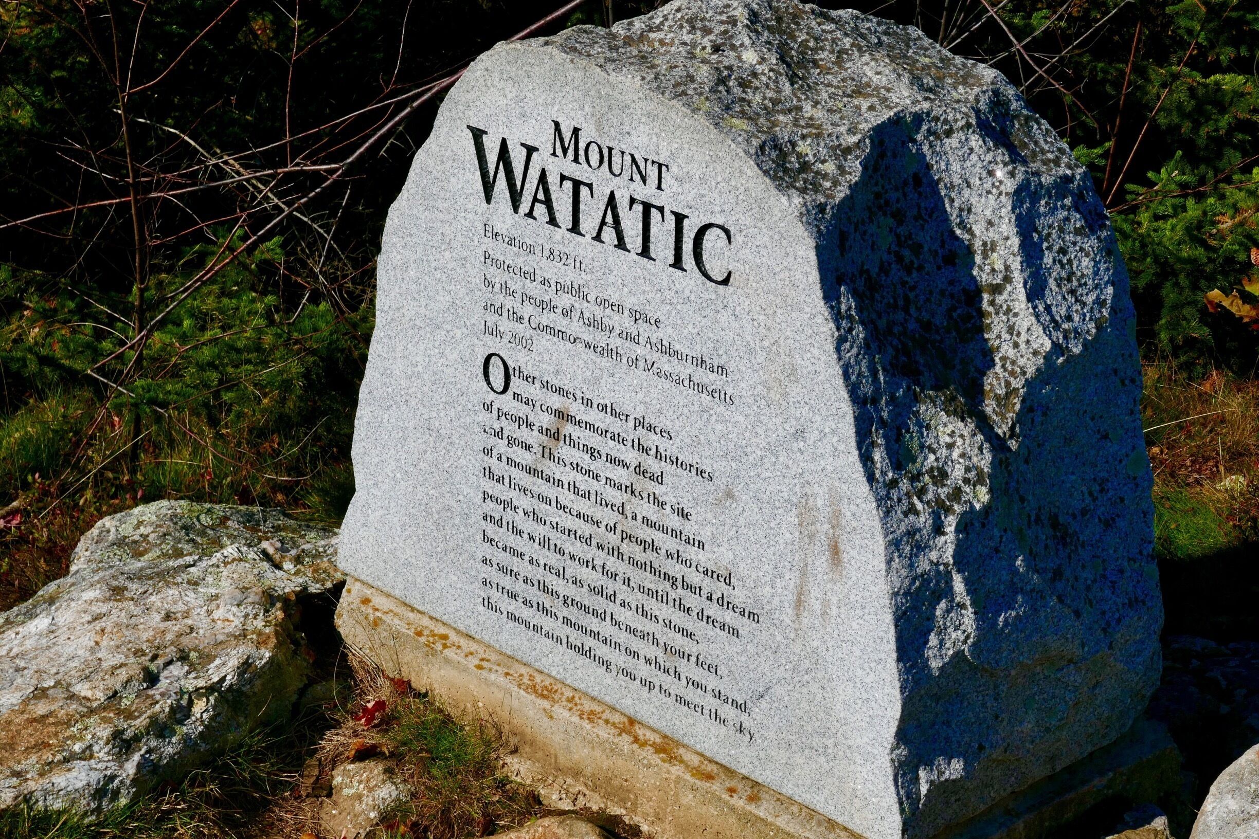 A granite monument with the inscription 'Mount WATATIC' and details about its elevation and historical significance.