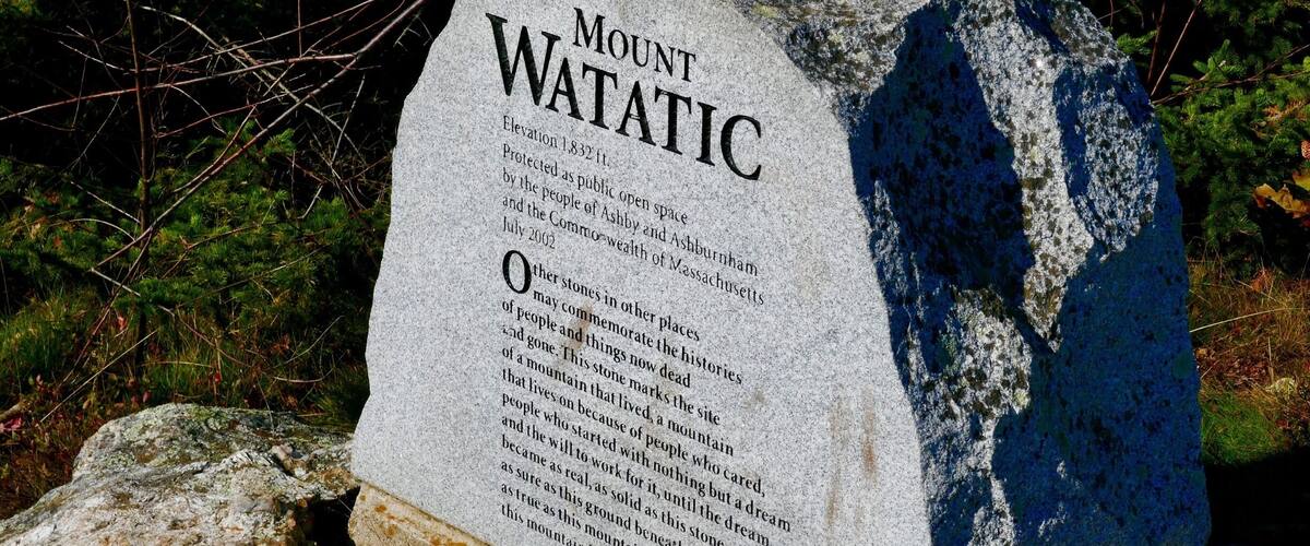 A granite monument with the inscription 'Mount WATATIC' and details about its elevation and historical significance.