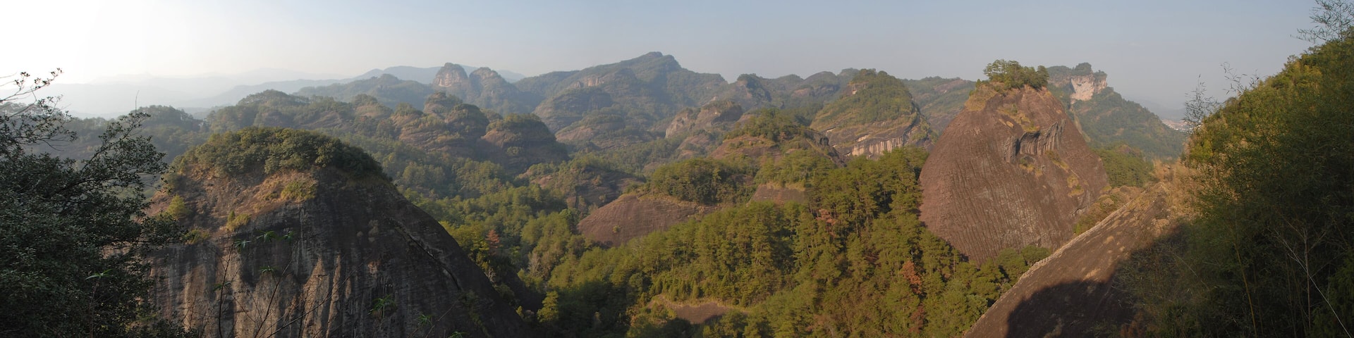 Wuyishan mountains in Fujian Province, China. Scenic view over the peaks of Wuyi mountains. A panoramic view of the hills from Roaring Tiger Rock. Wuyishan is a UNESCO World Heritage site in China.