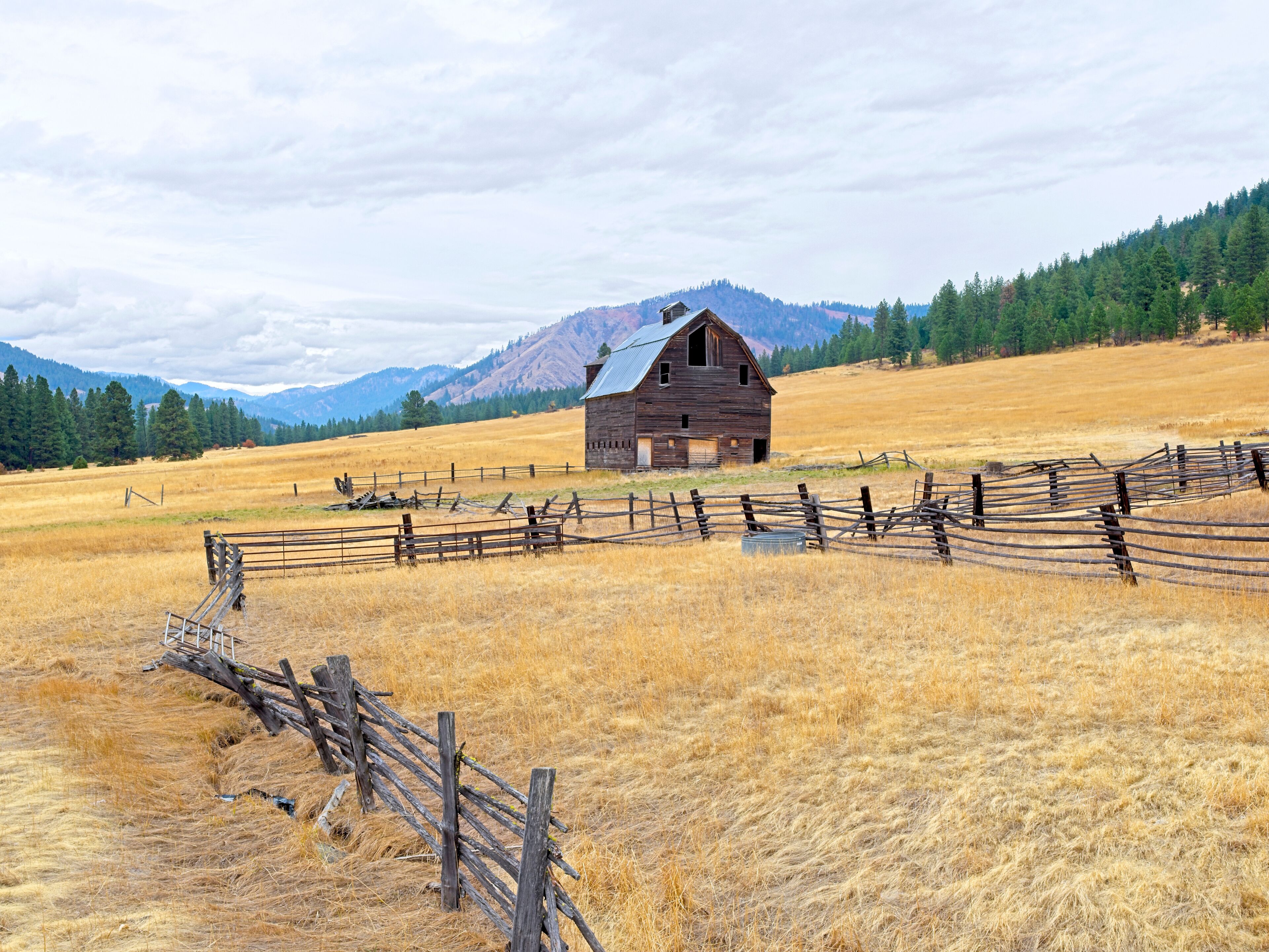Rural landscape of an old barn in a field.