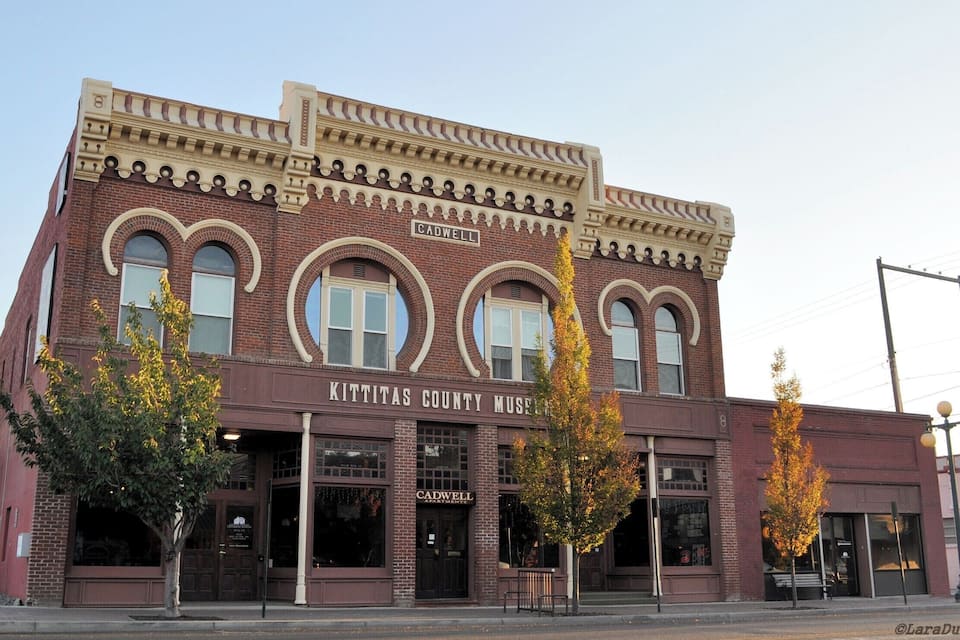 A historic building with arched windows and a sign reading "Kittitas County Museum".
