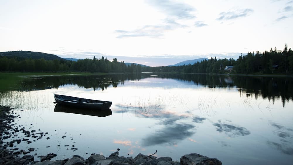 Rowboat on Indalsalven River at sunset in Undersaker Sweden